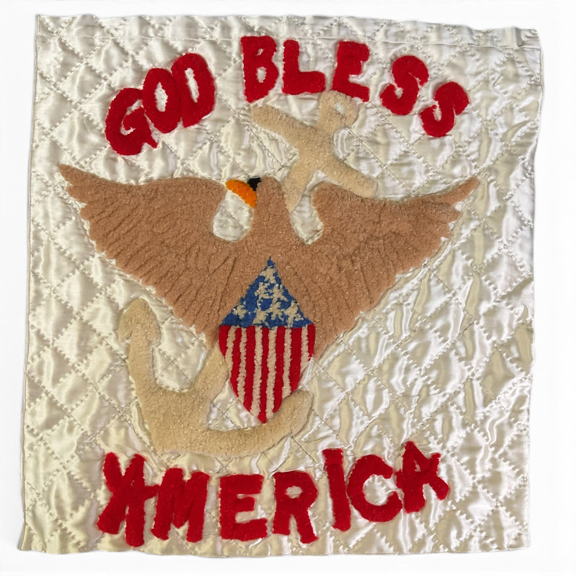 A square quilted patch featuring a punch needle embroidery brown eagle holding a beige anchor, with a red, white, and blue American flag motif on the chest. The patch has red embroidered text reading 'GOD BLESS' at the top and 'AMERICA' at the bottom, set against a creamy off white background.