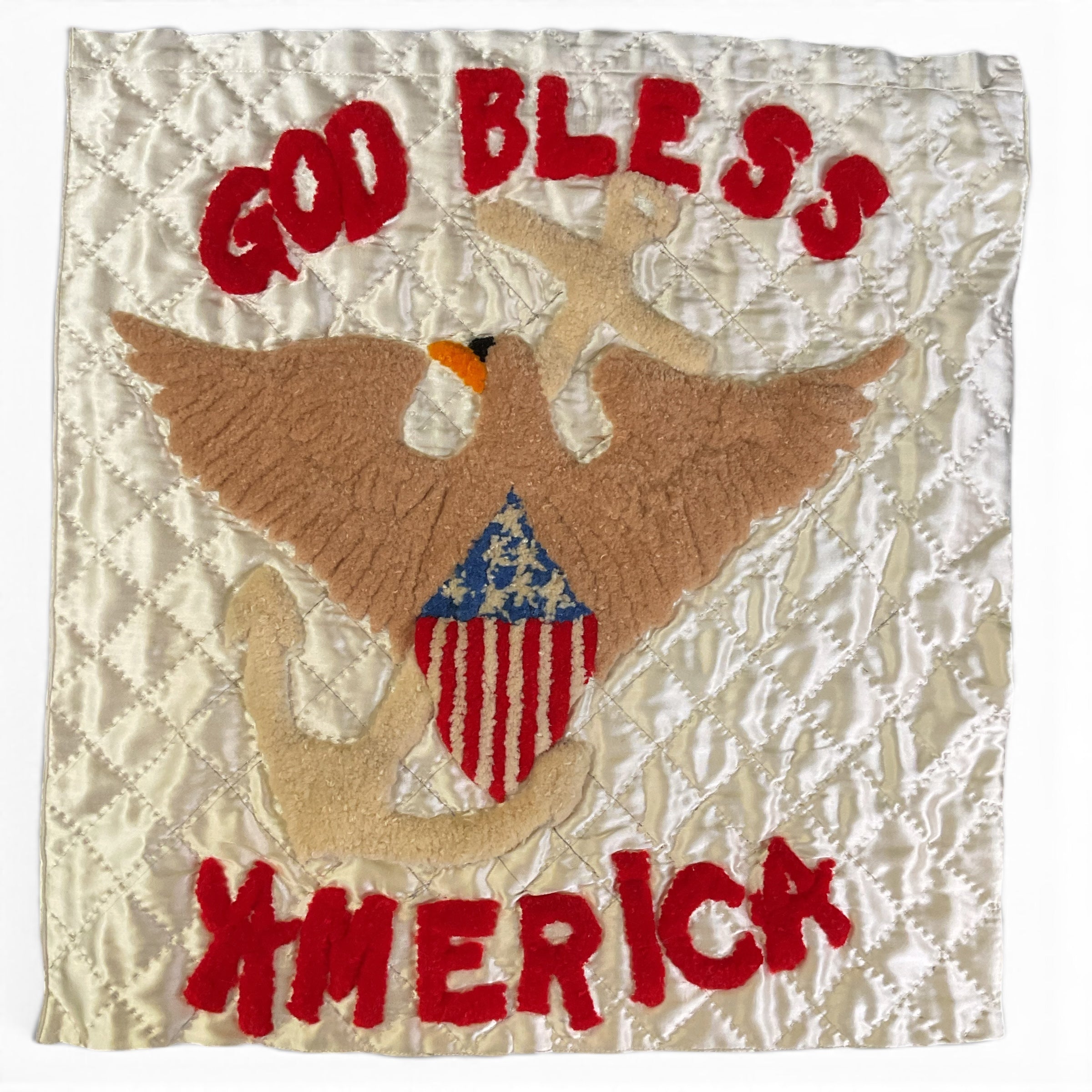 A square quilted patch featuring a punch needle embroidery brown eagle holding a beige anchor, with a red, white, and blue American flag motif on the chest. The patch has red embroidered text reading 'GOD BLESS' at the top and 'AMERICA' at the bottom, set against a creamy off white background.